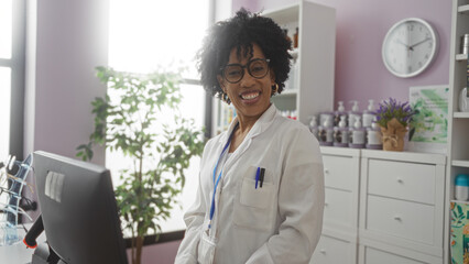 Smiling young african woman pharmacist stands in a modern, well-lit pharmacy interior, wearing a...