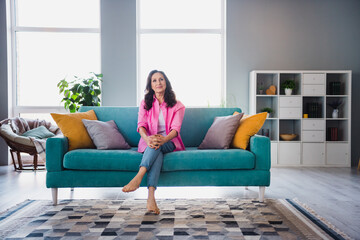 Photo of dreamy lovely senior woman wear stylish clothes sitting soft divan living room indoors