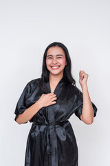 Happy asian woman in black silk bathrobe smiling