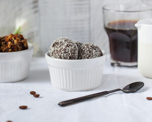 Craft chocolate candies with coconut flakes in ceramic bowl