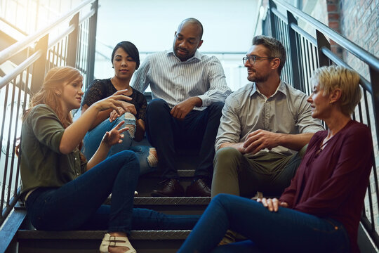 Office, steps and business people on break for discussion, hangout and talking to relax. Creative agency, men and women as journalist with conversation, opinion and listening in workplace stairs