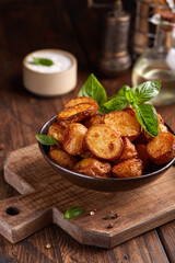 Baked potatoes. Potatoes with skin baked with olive oil and seasoning to golden color. Delicious snack served with sauce. Fast food. Side dish.