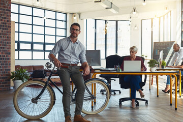 Bike, green business and portrait with man in office for carbon footprint or eco friendly work. Leadership, sustainability or transport and employee in workplace with bicycle for net zero commute