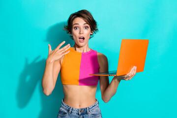 Photo of sweet shocked woman wear pink orange top getting message modern gadget isolated teal color...