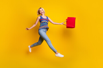 Full body length photo of shopaholic funny jumping woman in jeans and singlet enjoying warm spring...