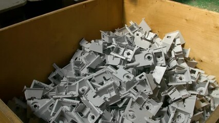 Plastic parts shop in a factory. Manufacturing of plastic parts and fittings for electric heaters in the factory. The machine stamps plastic parts