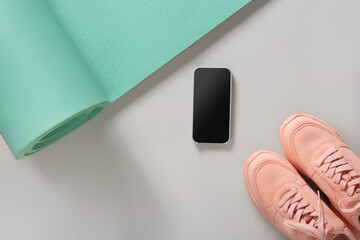 Sport and fitness equipment, black dumbbells, smartphone, pink fitness sneakers shoes for fun...