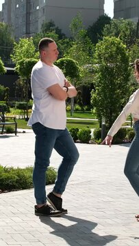 The guy and the girl turn to each other, stand with their backs turned to dance. Beautiful movement of women's hips