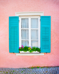 Obraz premium open window with green wooden shutters, pink texture wall