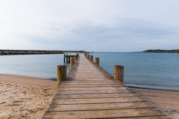Obraz premium Long wooden pier on the sea. Beautiful landscape view. 