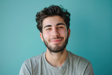 A close up portrait of a young man with a subtle smile