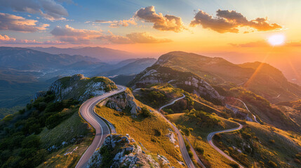 Aerial view of winding mountain road during sunset