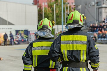 A team of confident and accomplished firefighters strides purposefully in their uniforms, exuding...