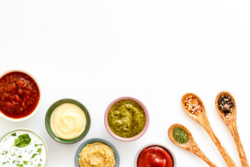 Bowls with various sauces and spices, top view. Food background