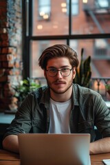 Obraz premium Young Professional Working on Laptop in Loft