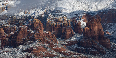The distant red cliffs of Sedona Arizona accenting in fresh snow.