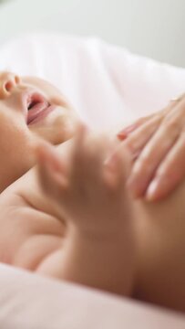 Mother applying moisturizing baby cream against dry skin. Concept of hygiene, baby care and healthcare.