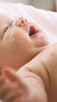 Mother applying moisturizing baby cream against dry skin. Concept of hygiene, baby care and healthcare.