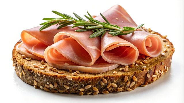 fresh ham in thing slices with fresh rosemary on a thin oval slice of bread with sesame seeds in the crust in white background