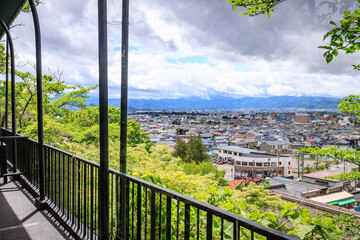 Fototapeta premium Panorama View from Iimori Mountain: Aizuwakamatsu’s Urban and Natural Harmony, Japan