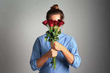 Rose, gift and shy woman in studio with bouquet for sorry, apology and understanding, mistake and...