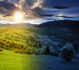 mountainous rural landscape on a summer solstice. fields and grassy meadows on rolling hills...
