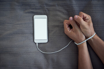 Phone screen, hands tied or internet addiction with cable handcuff on bed with above mockup for...