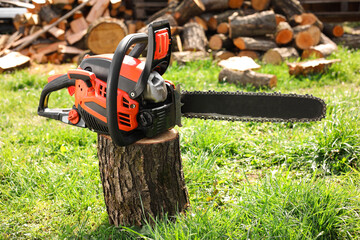 One modern saw on wooden log on sunny day