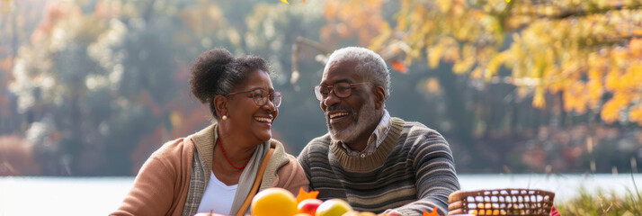 an African American retired couple having a picnic by the lake