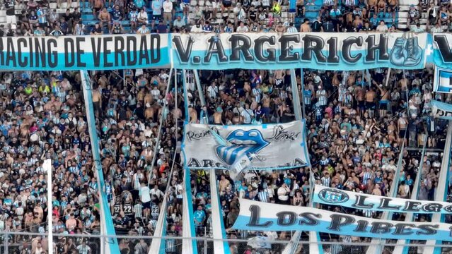 Buenos Aires, Argentina, January 31, 2024: Aerial view of the Racing Club stadium at sunset. Racing fans celebrating ("El Cilindro de Avellaneda")