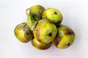 Asian palmyra palm fruit (Borassus flabellifer) isolated on white background. It is also known as toddy palm or sugar palm.