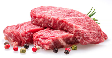 Raw pieces of beef with peppercorn and rosemary isolated on white background. Closeup.