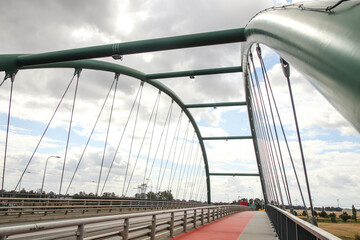Obraz premium Car on a bridge, urban landscape, wide angle. Automobile on a highway, urban transportation, road curve