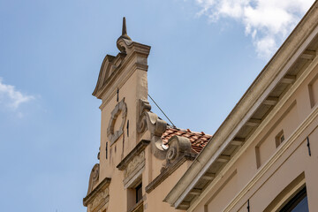 Person on the roof maintenance typical cant historic medieval exterior facade of Hanseatic city center against a clear blue sky. Europe tourism destination.