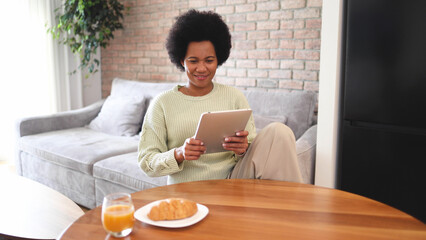 Happy African woman using tablet