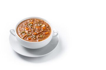 Lentil soup with vegetables in bowl isolated on white background. Top view. Copy space