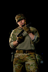 at a professional shooting range a military weapons trainer standing screws on a silencer