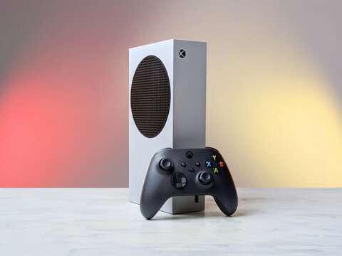 Microsoft Xbox Series S and a black gamepad on the table