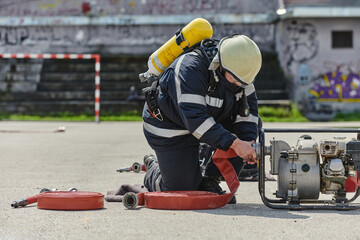 A firefighter dons the essential components of their professional gear, embodying resilience,...
