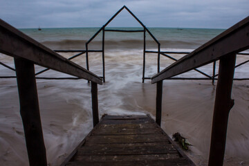 Long exposure of waves around a small wooden gate at the Inhassoro coastline, Mozambique