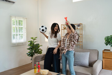 At Home Soccer Fans Sitting on a Couch Watch Football Game on TV, Cheer for Favourtite Sports Team...