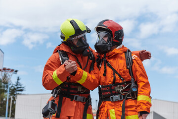 A unified team of firefighters, adorned in their uniforms, engages in a heartfelt celebration...