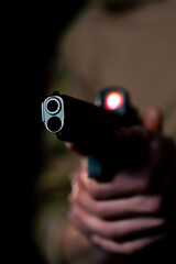 close-up at a professional shooting range a military trainer in ammunition takes aim with a pistol