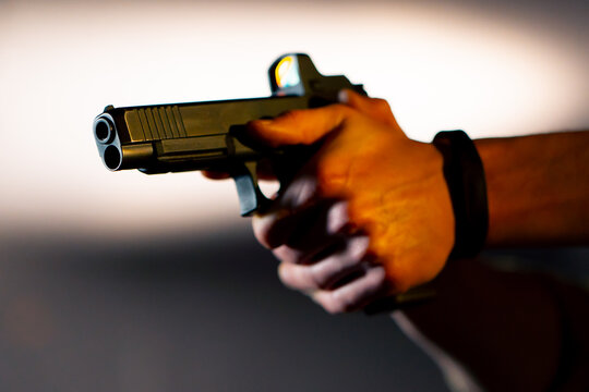 close up at a professional shooting range a military trainer reloading a pistol ready to shoot