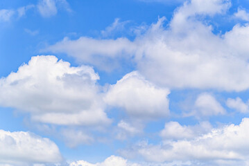 Obraz premium White clouds in a bright blue sky. The beauty of the nature 