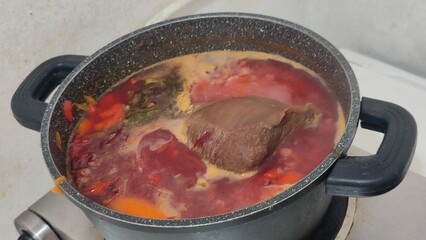 red soup with beef in a pan food cooking lunch dinner