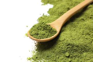 Green matcha powder and wooden spoon isolated on white