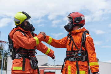 A unified team of firefighters, adorned in their uniforms, engages in a heartfelt celebration...