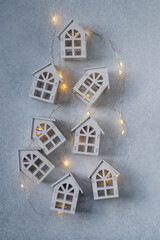 New Year's garland. Christmas background. Gray wooden toy houses