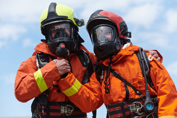 A unified team of firefighters, adorned in their uniforms, engages in a heartfelt celebration...